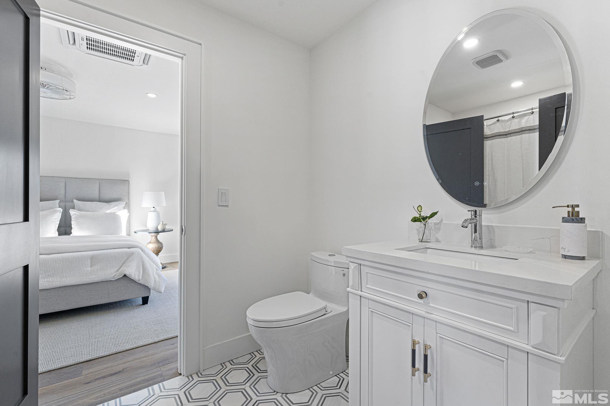 2620 Del Monte Lane Reno, NV 89511 - Photo 33 of 40 a bathroom with a toilet a sink and a mirror
