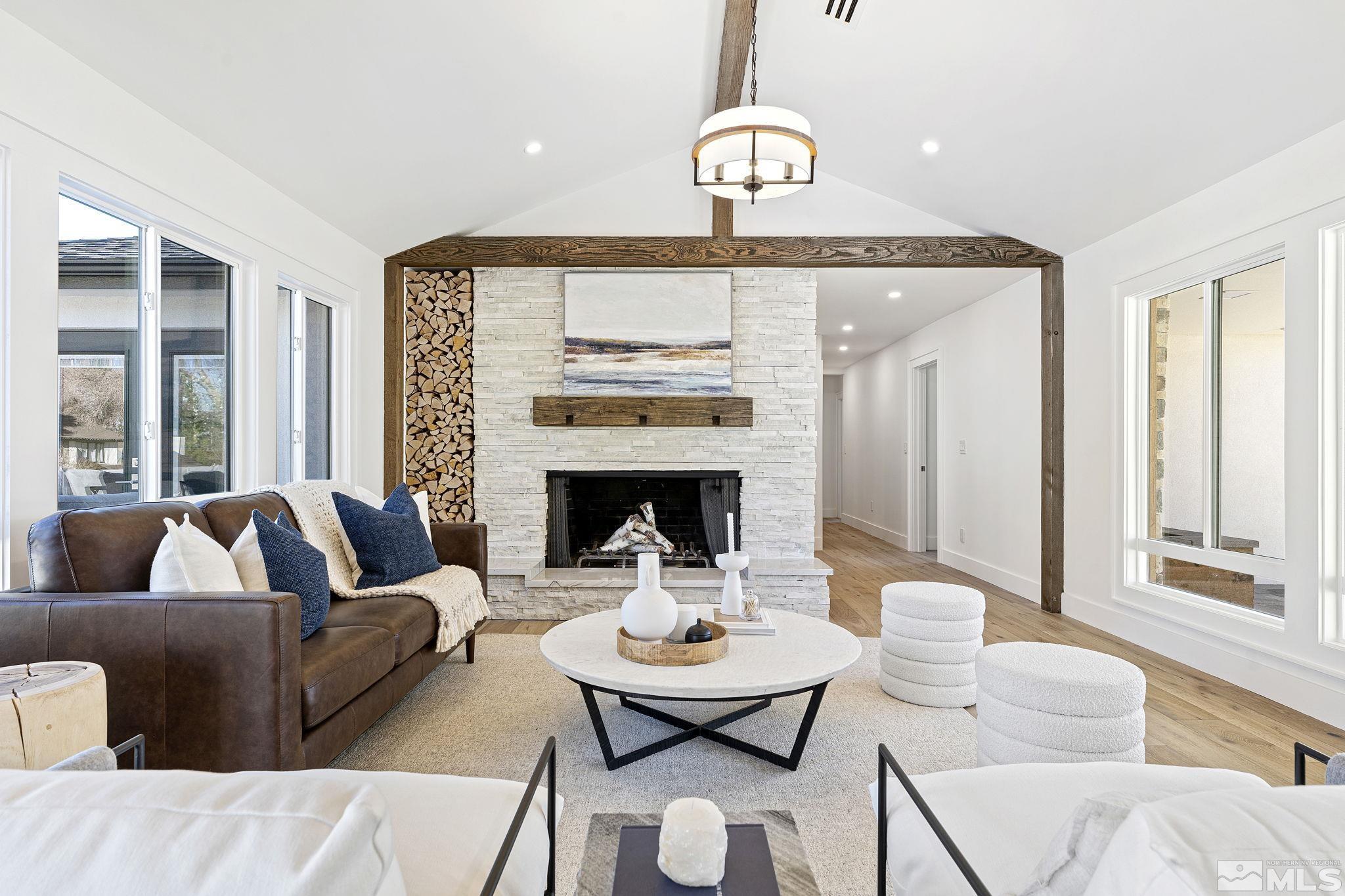 2620 Del Monte Lane Reno, NV 89511 - Photo 10 of 40 a living room with furniture a fireplace and a large window