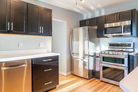 a kitchen with a refrigerator stove and microwave