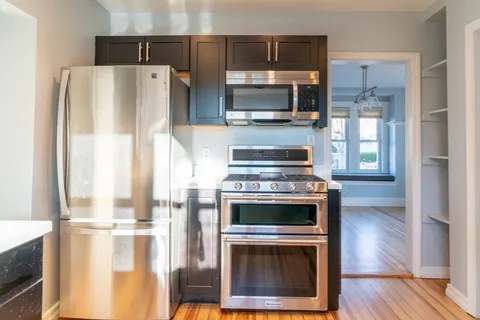 a kitchen with a stove and a refrigerator