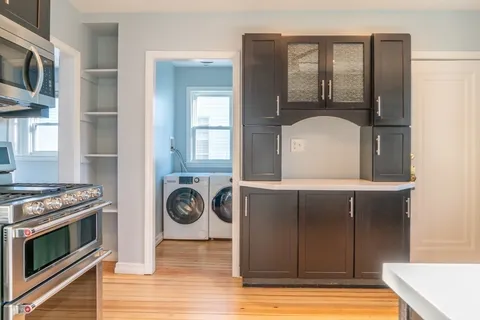 a view of washer and dryer with wooden floor