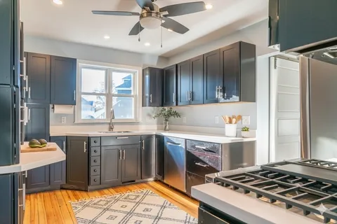 a kitchen with a sink stove and refrigerator