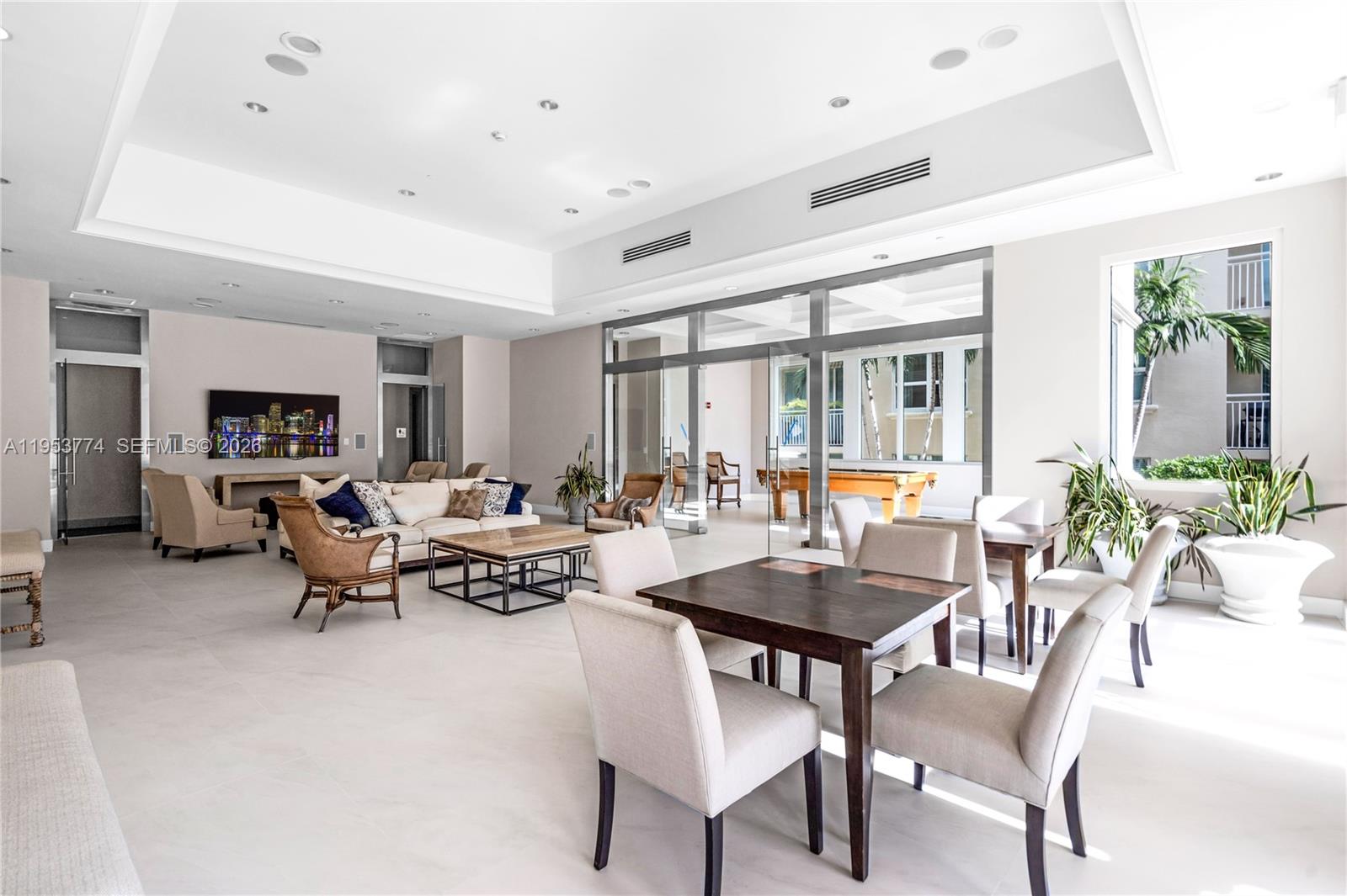 99 Southeast Mizner Boulevard, Unit 409 Boca Raton, FL 33432 - Photo 14 of 26 a living room with furniture and a potted plant