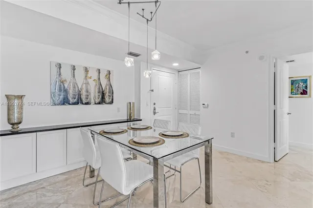 a view of a dining room with furniture and a chandelier