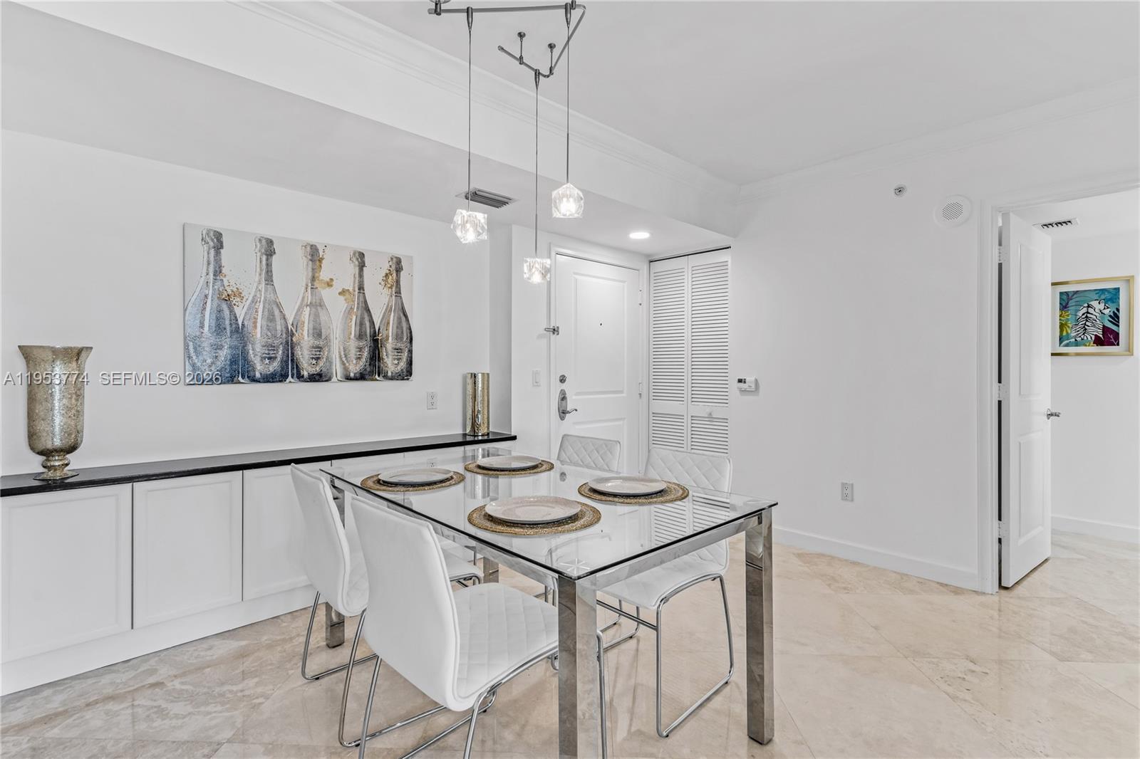 99 Southeast Mizner Boulevard, Unit 409 Boca Raton, FL 33432 - Photo 4 of 26 a view of a dining room with furniture and a chandelier
