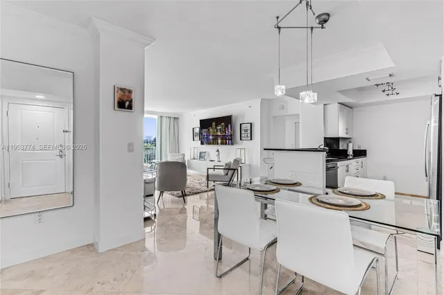 a kitchen with kitchen island granite countertop a table and chairs in it