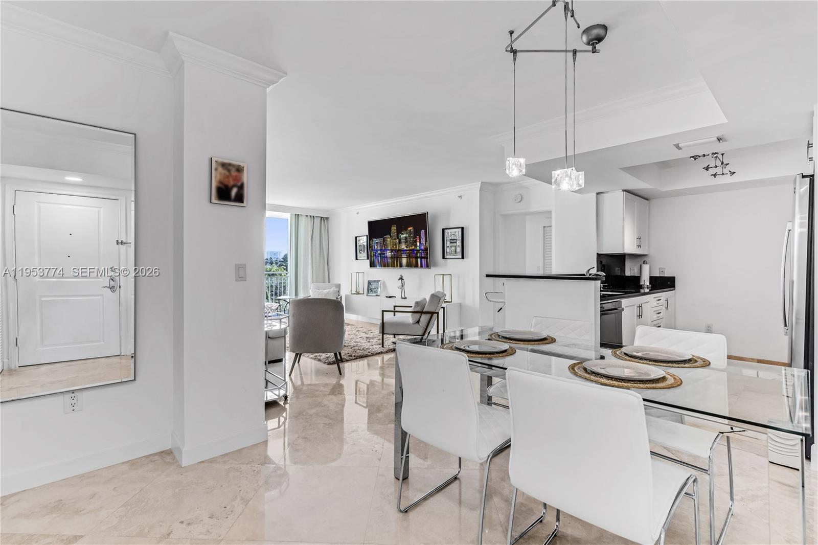 99 Southeast Mizner Boulevard, Unit 409 Boca Raton, FL 33432 - Photo 5 of 26 a kitchen with kitchen island granite countertop a table and chairs in it