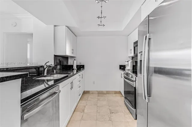 a kitchen with a sink stove and refrigerator
