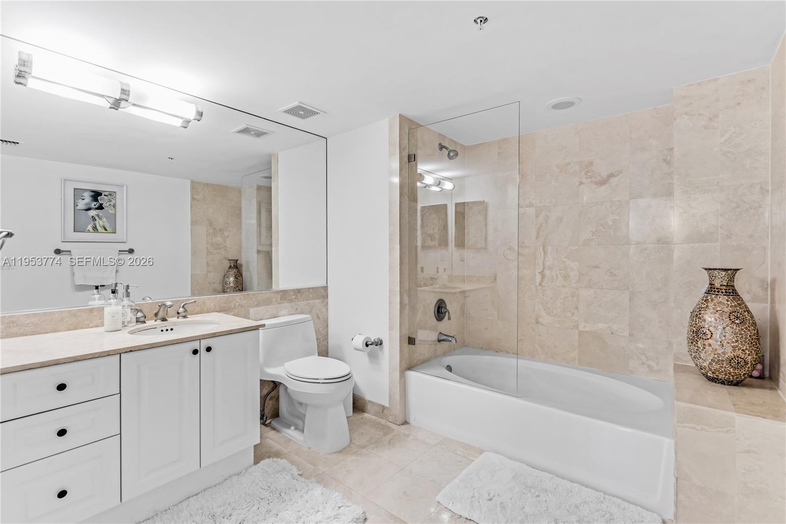 99 Southeast Mizner Boulevard, Unit 409 Boca Raton, FL 33432 - Photo 8 of 26 a bathroom with a bathtub shower sink and toilet