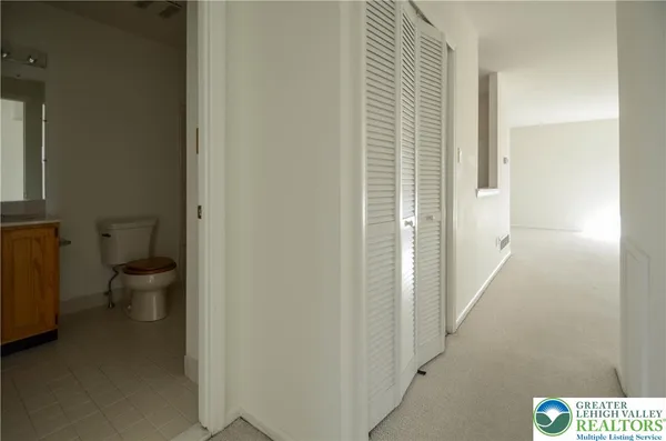 a view of a hallway with toilet