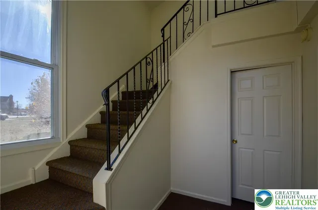 a view of entryway with wooden floor and stairs