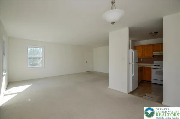 a view of a kitchen with a sink and refrigerator