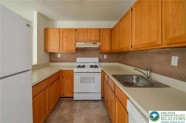 a kitchen with a sink cabinets and a window