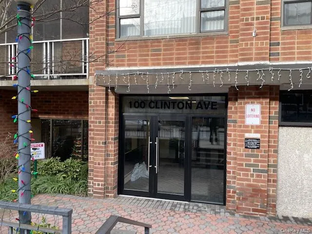 a view of a brick building with a door and a outdoor space