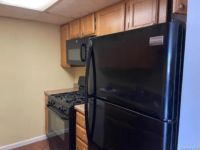 a metallic refrigerator freezer sitting in a kitchen