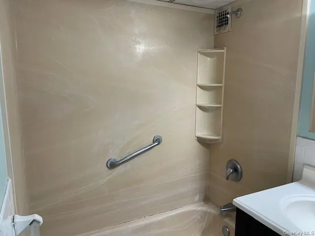 a bathroom with a shower and a sink