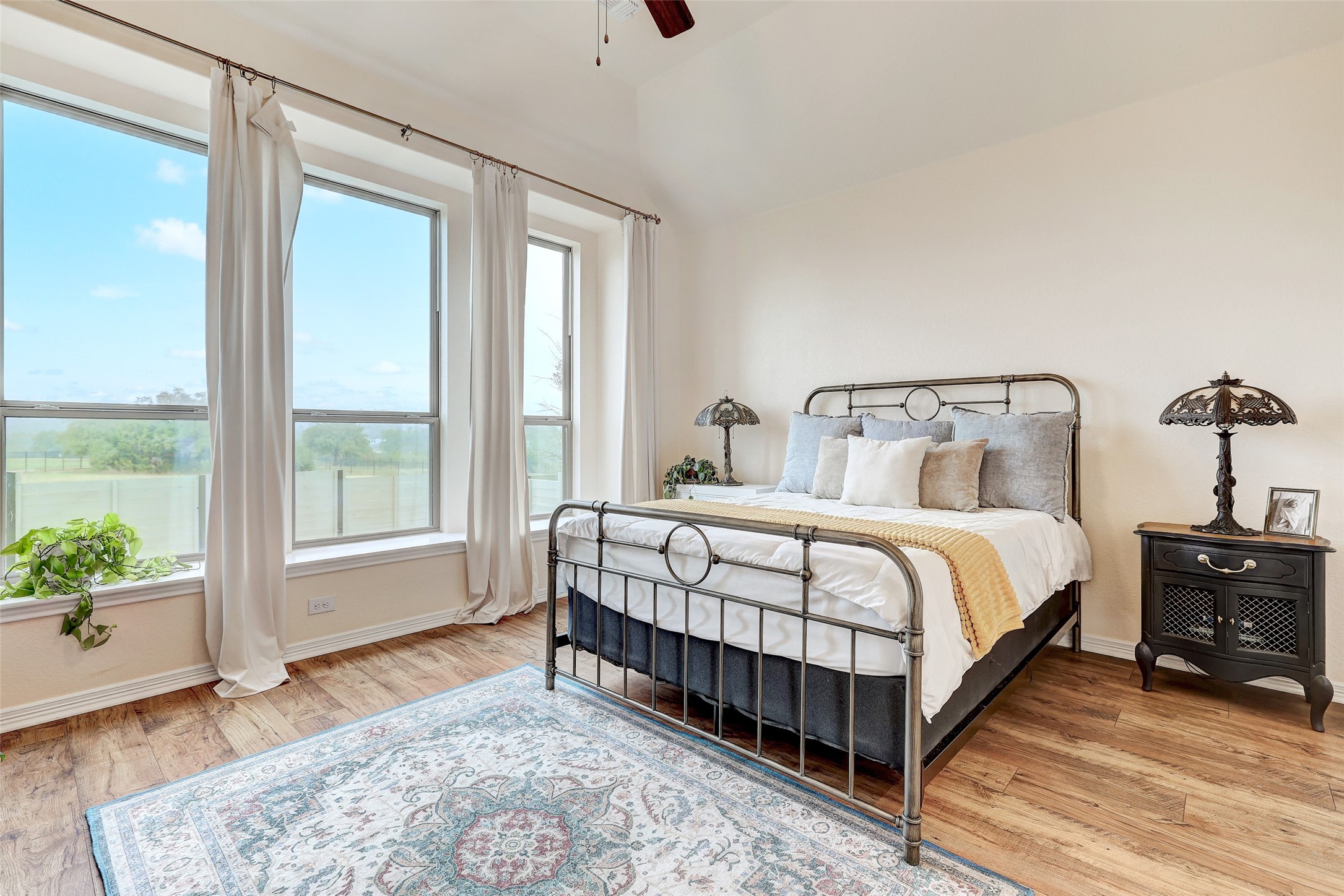 1117 Spring Gulch Lane Georgetown, TX 78628 - Photo 19 of 39 Wood flooring and abundant natural light create a welcoming and comfortable primary bedroom.