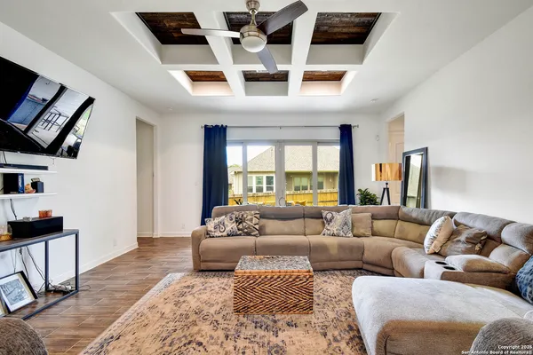 a living room with furniture ceiling fan and a rug