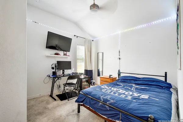 a bedroom with furniture and a flat screen tv