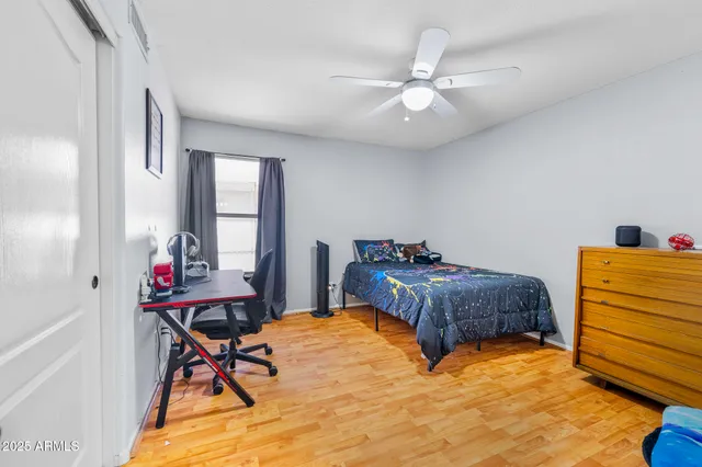 a spacious bedroom with a bed and a chandelier