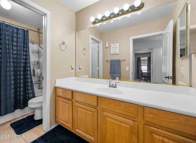 a spacious bedroom with a bed and a flat screen tv