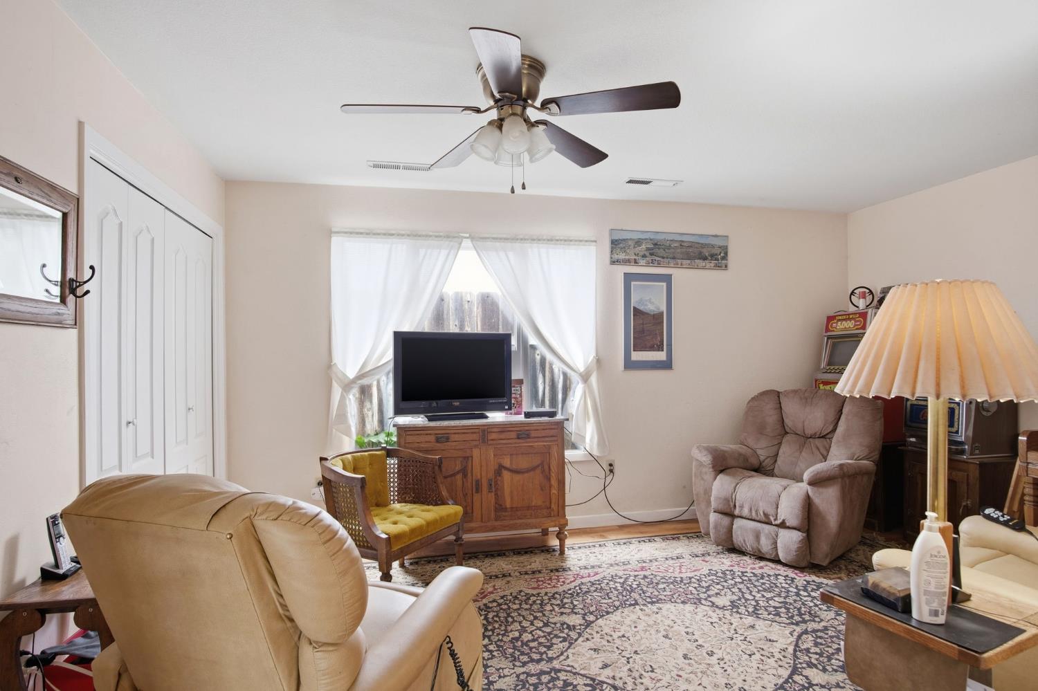 1740 Colorado Avenue Turlock, CA 95382 - Photo 11 of 37 a living room with furniture and a flat screen tv