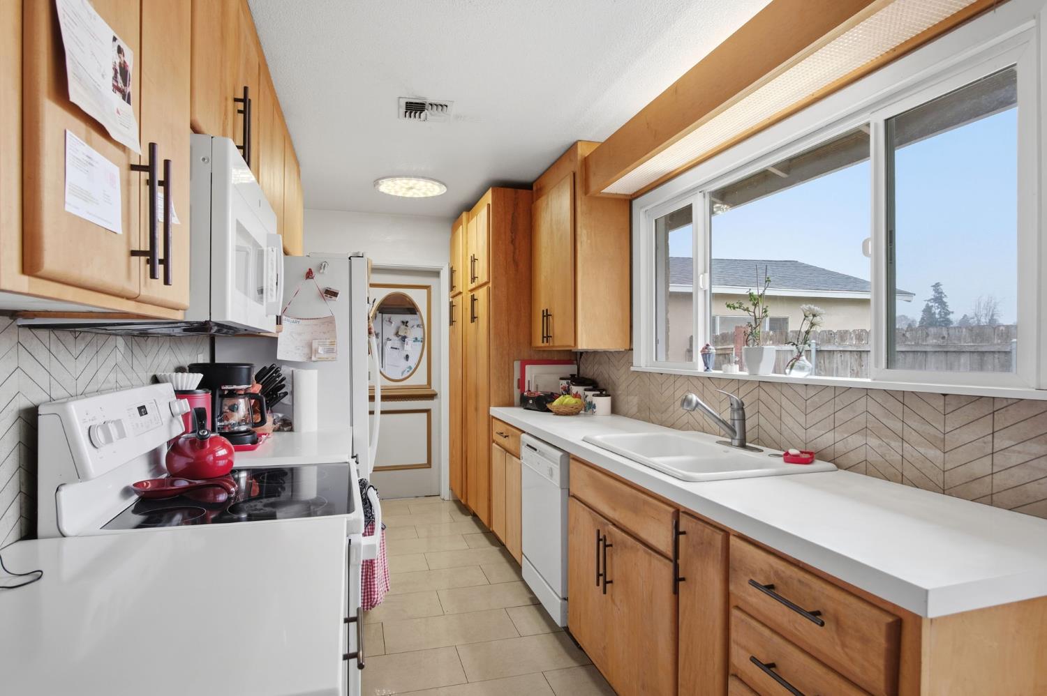 1740 Colorado Avenue Turlock, CA 95382 - Photo 12 of 37 a kitchen with sink a cabinets and window
