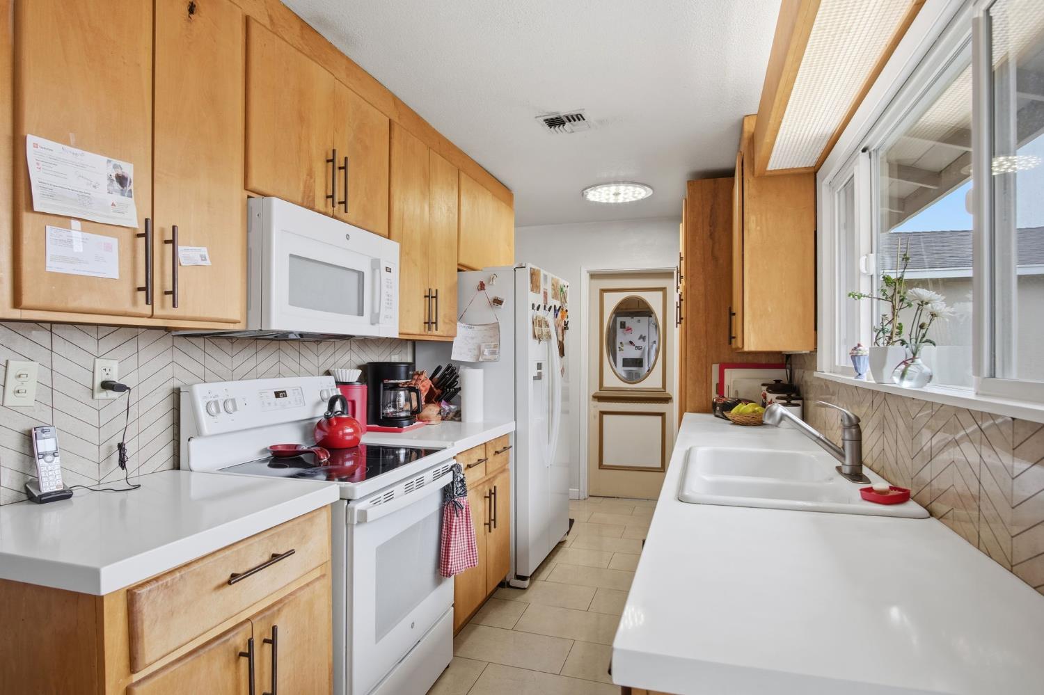 1740 Colorado Avenue Turlock, CA 95382 - Photo 13 of 37 a kitchen with a sink cabinets and window