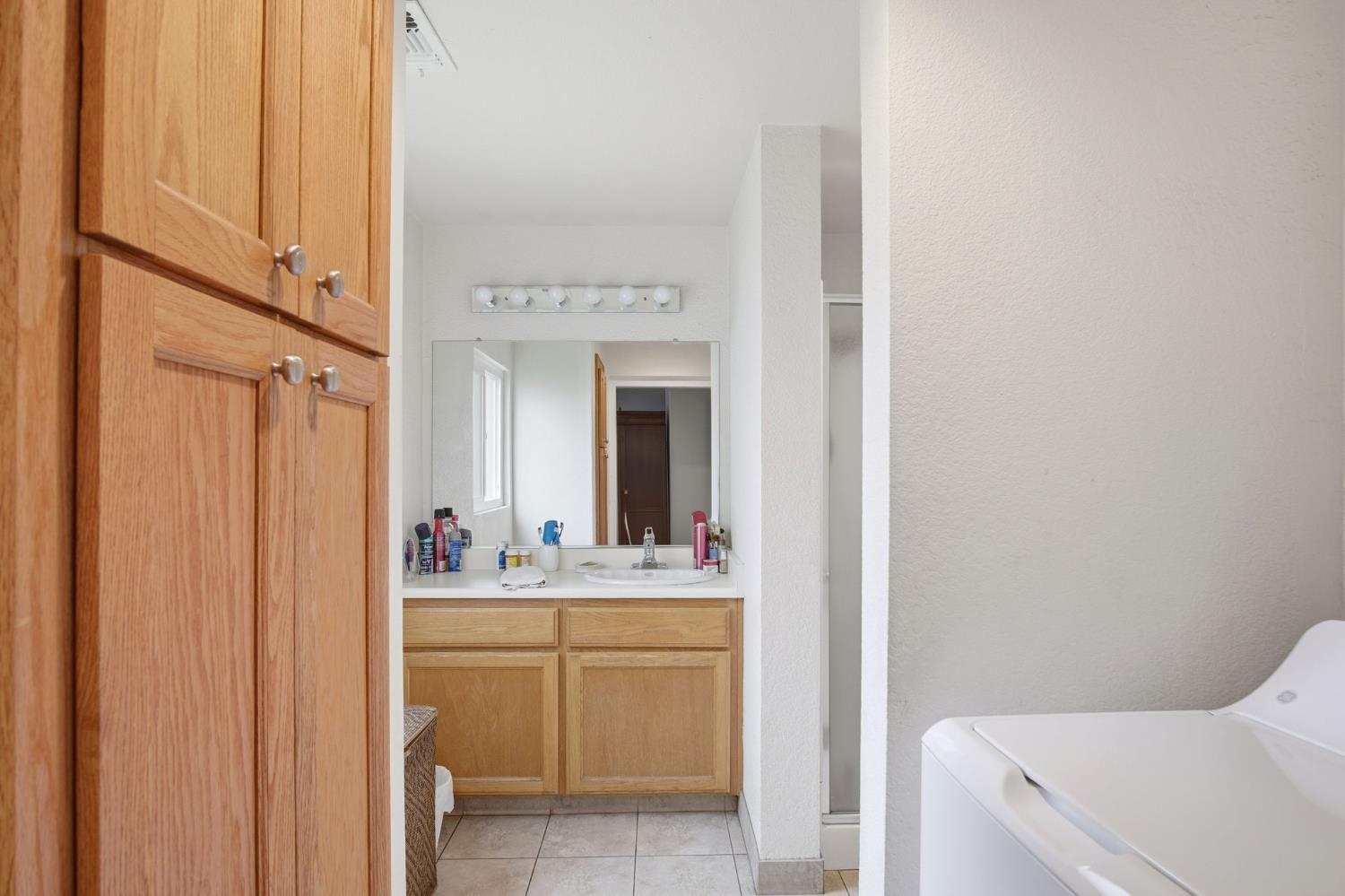 1740 Colorado Avenue Turlock, CA 95382 - Photo 17 of 37 a bathroom with a sink a vanity and a mirror