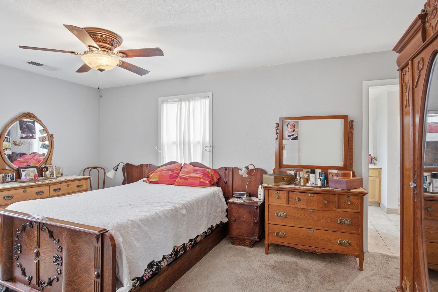 1740 Colorado Avenue Turlock, CA 95382 - Photo 20 of 37 a bedroom with a bed and a chandelier