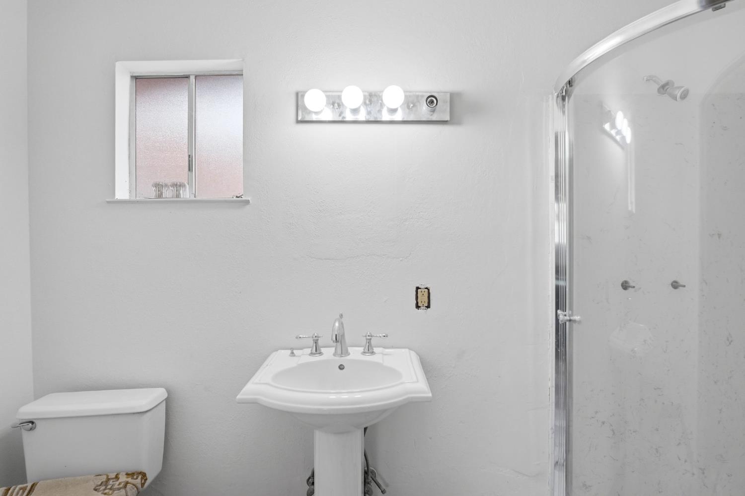 1740 Colorado Avenue Turlock, CA 95382 - Photo 30 of 37 a bathroom with a sink mirror and toilet
