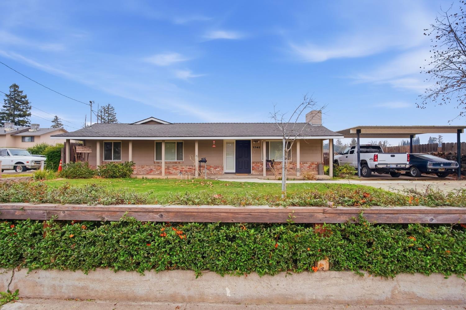 1740 Colorado Avenue Turlock, CA 95382 - Photo 3 of 37 a front view of a house with a garden and plants