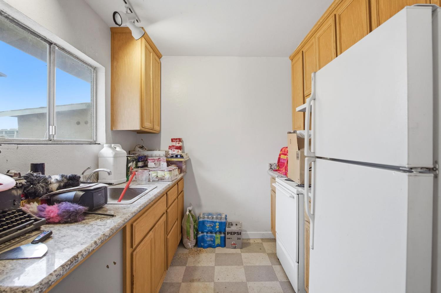 1740 Colorado Avenue Turlock, CA 95382 - Photo 32 of 37 a kitchen with a sink refrigerator and cabinets