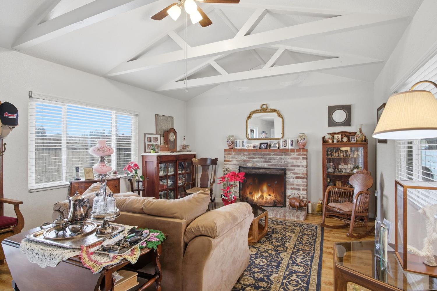 1740 Colorado Avenue Turlock, CA 95382 - Photo 8 of 37 a living room with furniture a fireplace and a large window