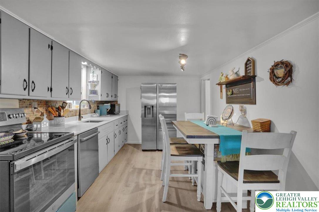 1825 Moselem Spring Road Hamburg, PA 19526 - Photo 12 of 24 a kitchen with stainless steel appliances granite countertop a stove top oven a sink a counter space and cabinets
