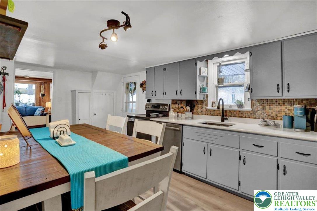 1825 Moselem Spring Road Hamburg, PA 19526 - Photo 13 of 24 a kitchen with a table chairs and white cabinets