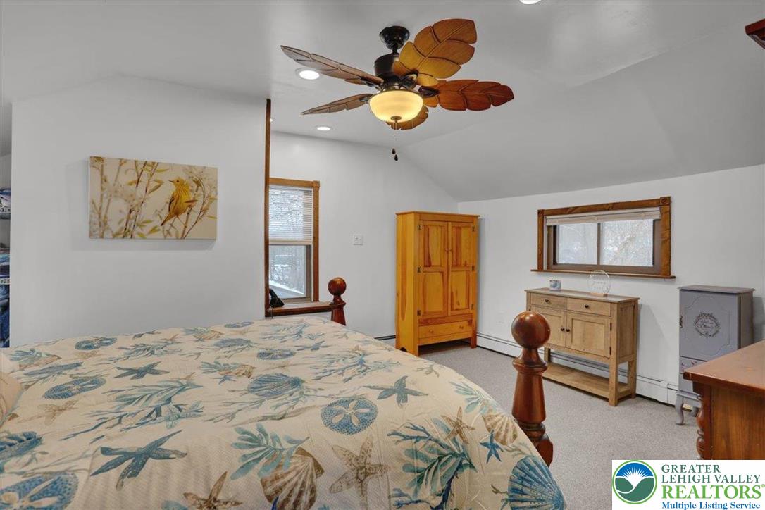 1825 Moselem Spring Road Hamburg, PA 19526 - Photo 18 of 24 a bedroom with a bed a couch and a chandelier