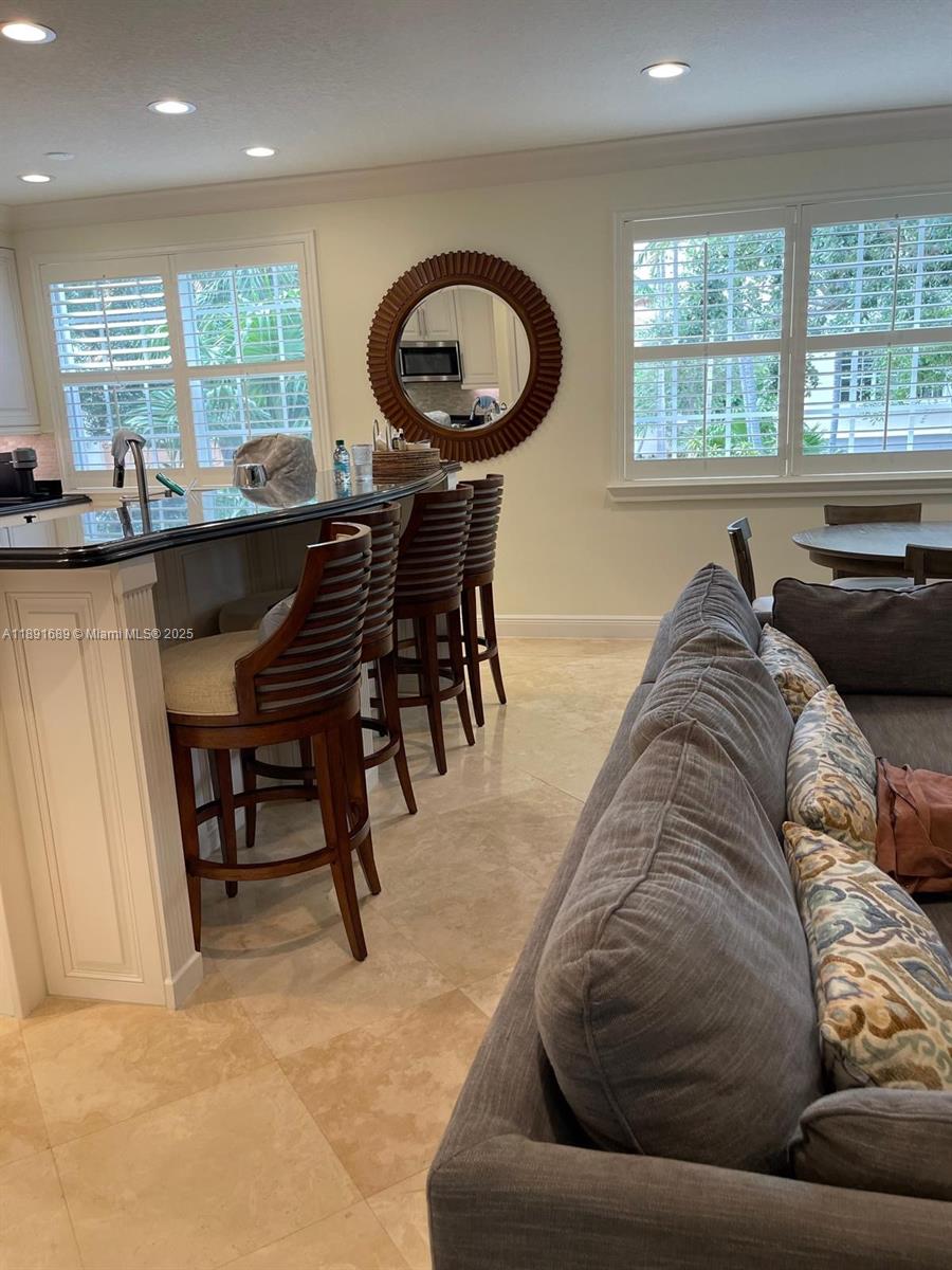 5565 Northeast Trieste Way Boca Raton, FL 33487 - Photo 12 of 30 a living room with furniture and a large window