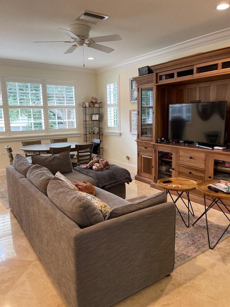 5565 Northeast Trieste Way Boca Raton, FL 33487 - Photo 13 of 30 a living room with furniture and a flat screen tv