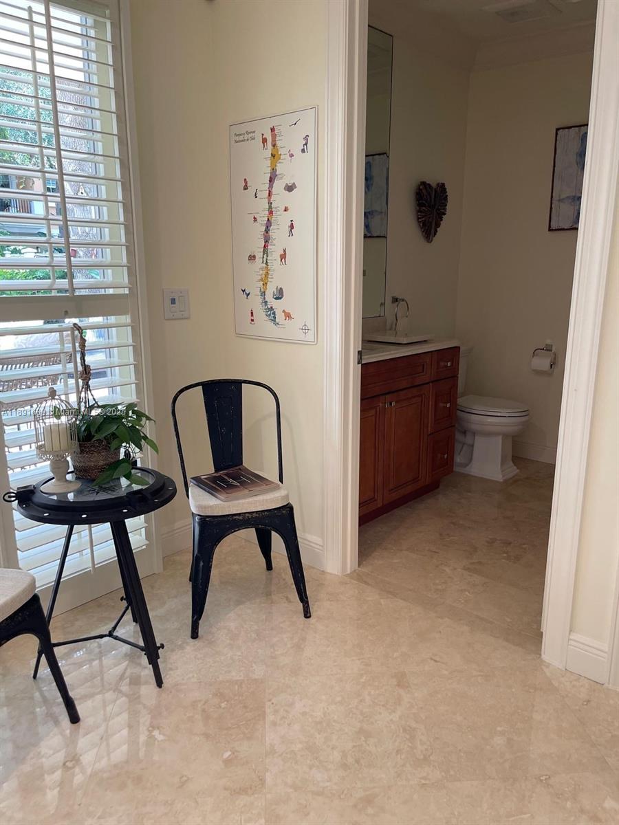 5565 Northeast Trieste Way Boca Raton, FL 33487 - Photo 15 of 30 a view of a workspace with furniture and a window