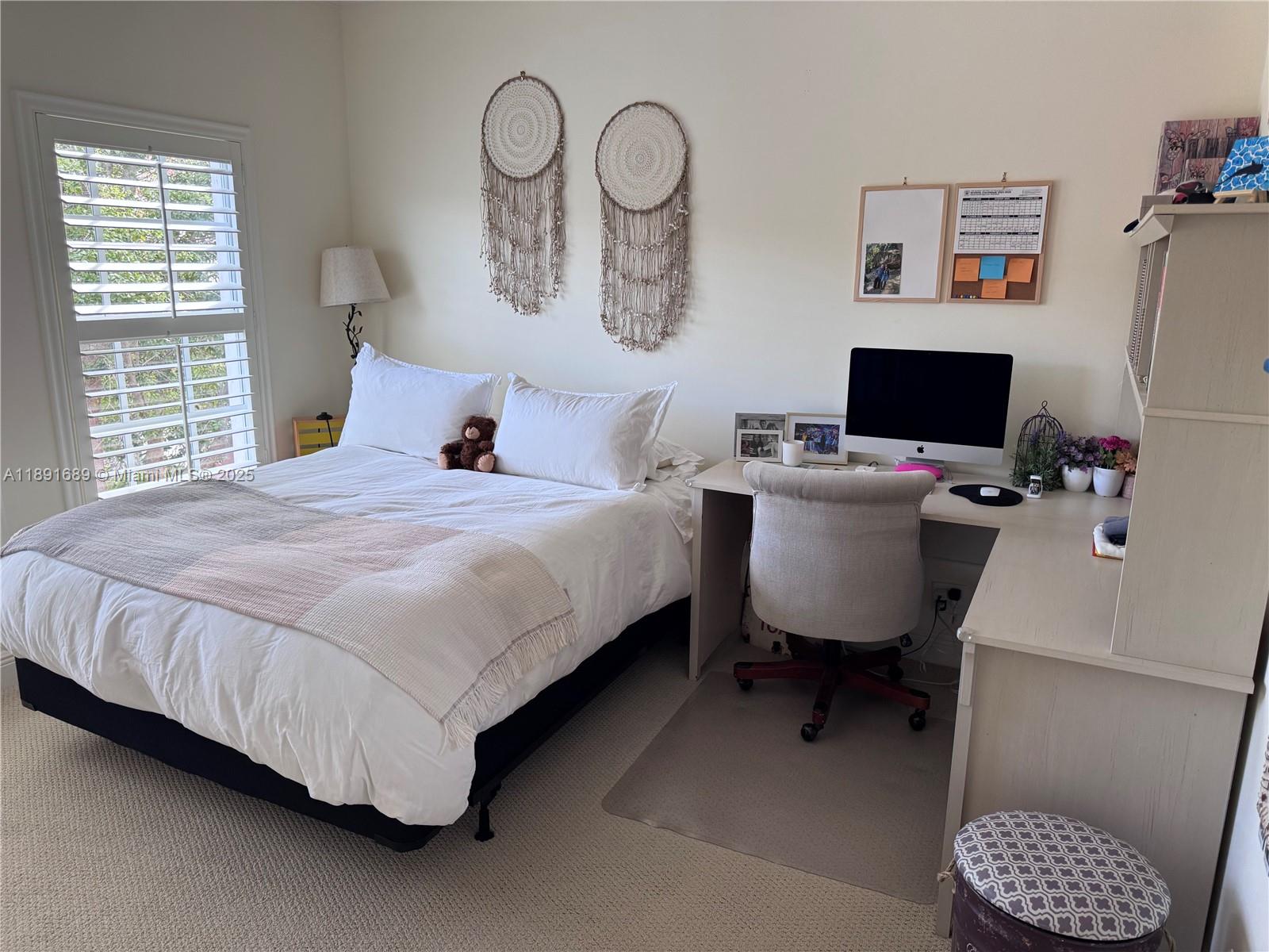 5565 Northeast Trieste Way Boca Raton, FL 33487 - Photo 17 of 30 a bedroom with a bed and a desk