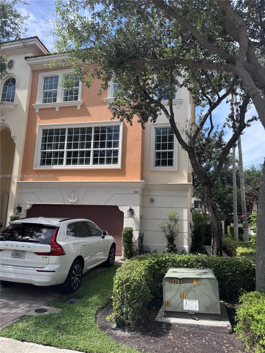 5565 Northeast Trieste Way Boca Raton, FL 33487 - Photo 2 of 30 a front view of a house with a garden