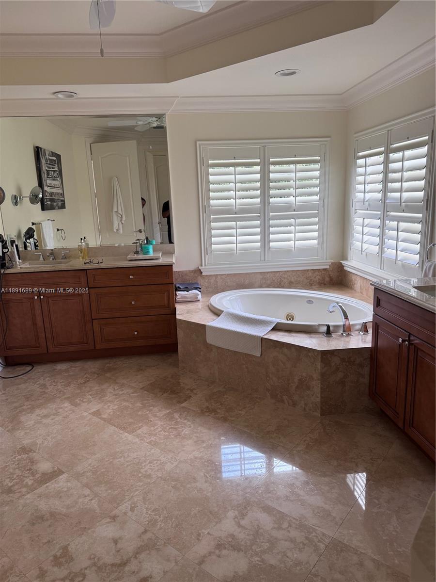 5565 Northeast Trieste Way Boca Raton, FL 33487 - Photo 21 of 30 a spacious bathroom with a bathtub and a sink