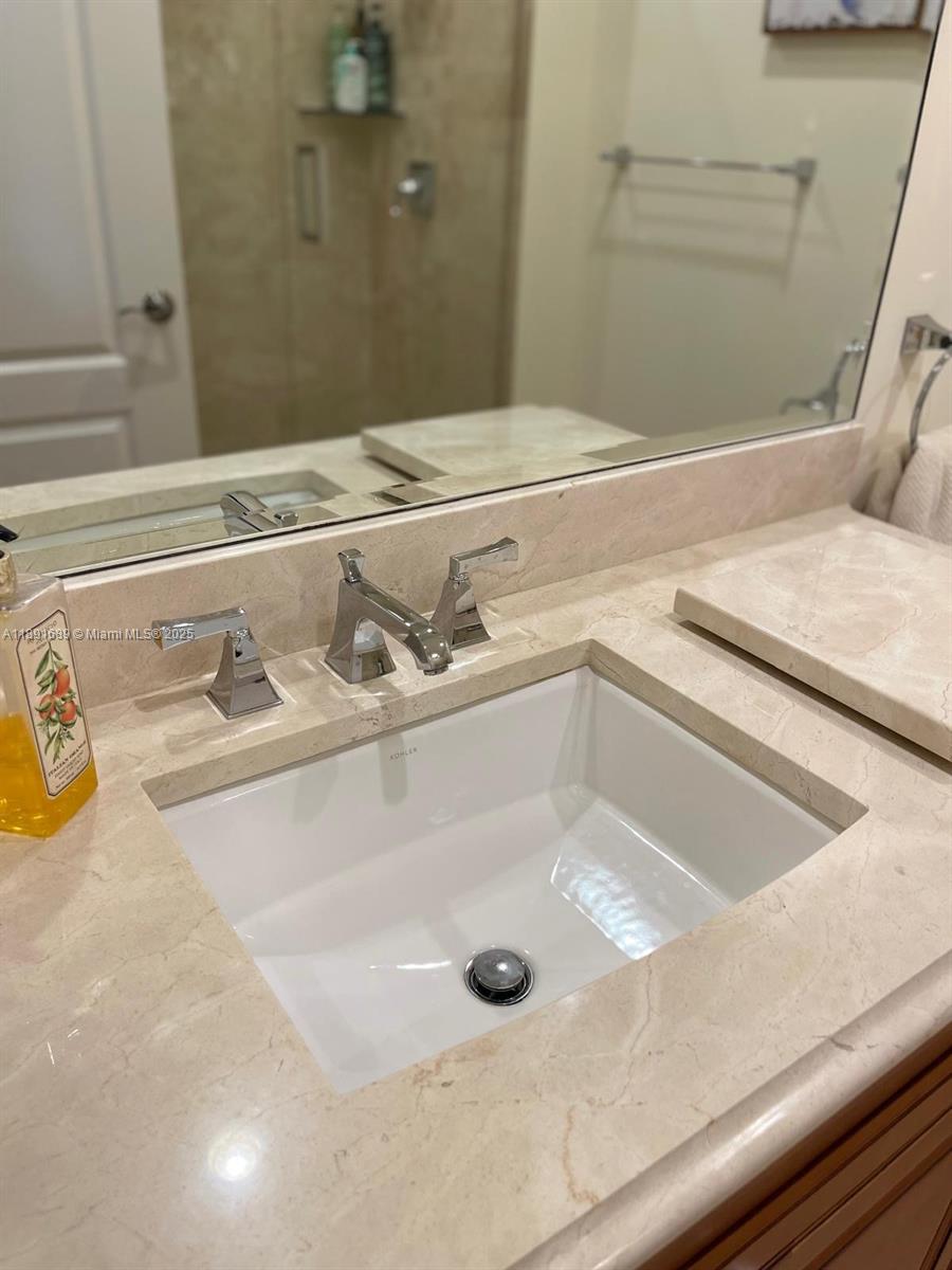 5565 Northeast Trieste Way Boca Raton, FL 33487 - Photo 24 of 30 a bathroom with a tub