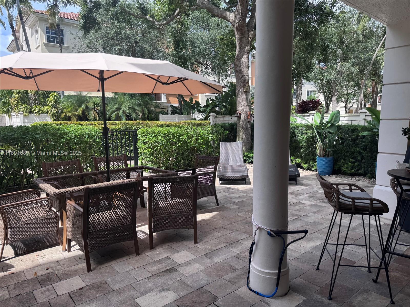 5565 Northeast Trieste Way Boca Raton, FL 33487 - Photo 29 of 30 a patio with patio area and outdoor seating