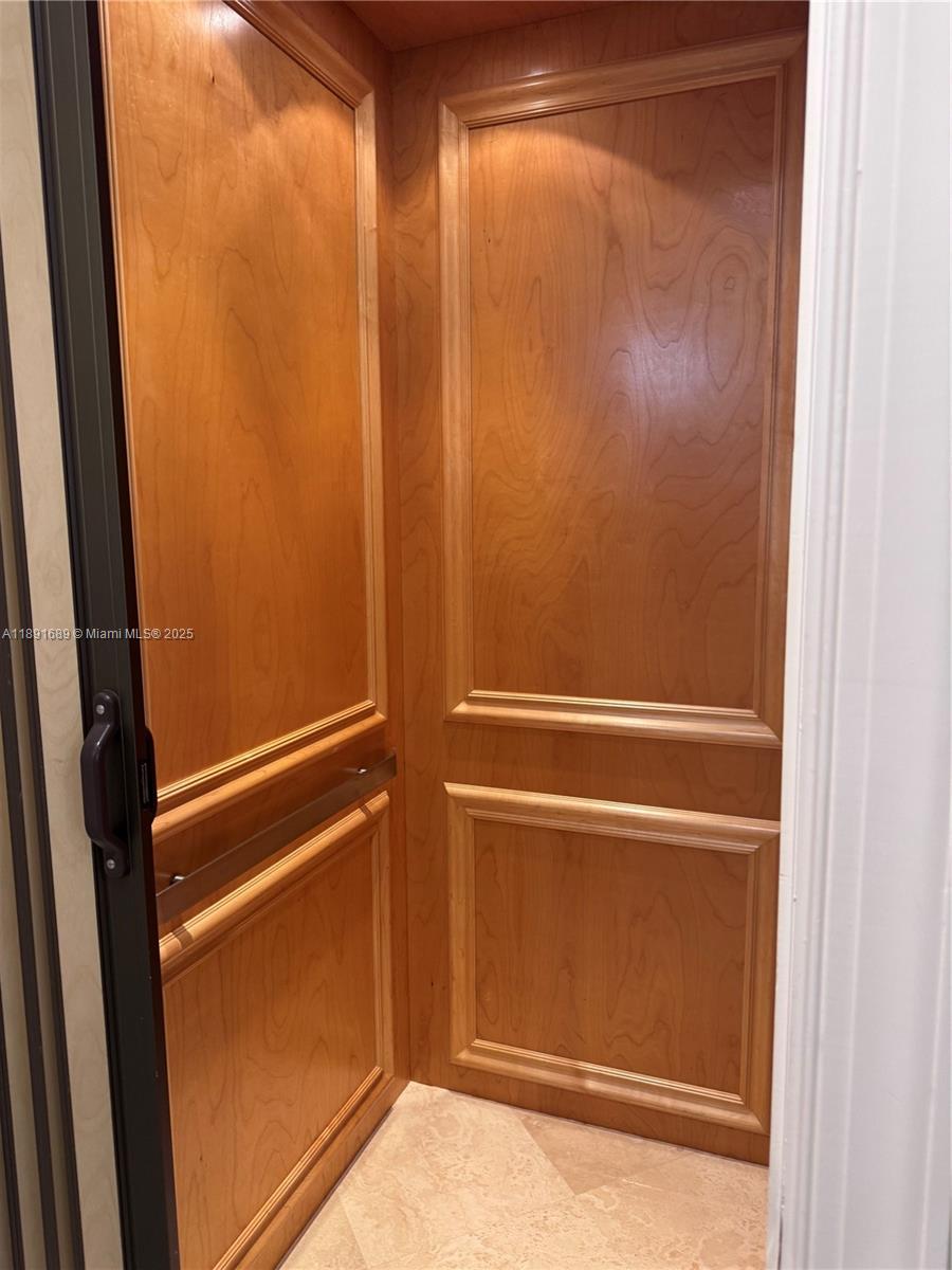 5565 Northeast Trieste Way Boca Raton, FL 33487 - Photo 6 of 30 a bathroom with a glass shower door