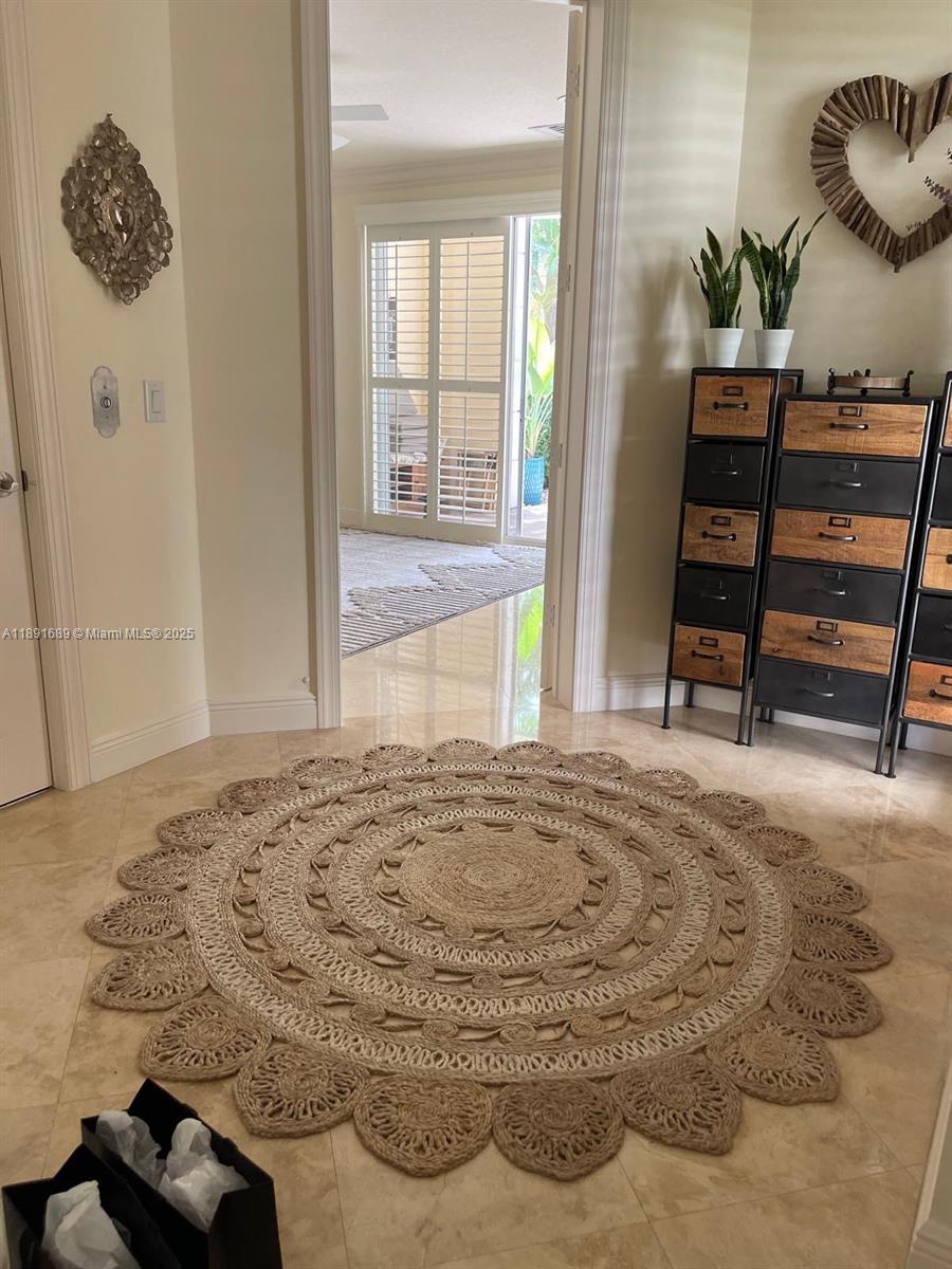 5565 Northeast Trieste Way Boca Raton, FL 33487 - Photo 7 of 30 a bedroom with a bed and wooden floor