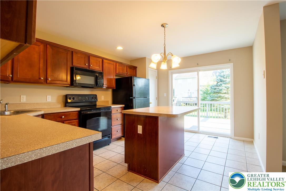 4138 Walter Road Bethlehem, PA 18020 - Photo 11 of 39 a kitchen with stainless steel appliances a stove sink and microwave