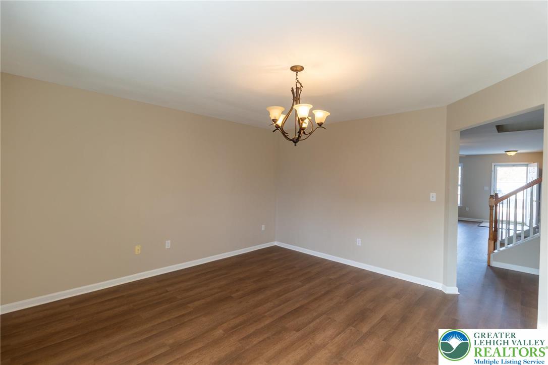 4138 Walter Road Bethlehem, PA 18020 - Photo 13 of 39 a view of a room with wooden floor and chandelier