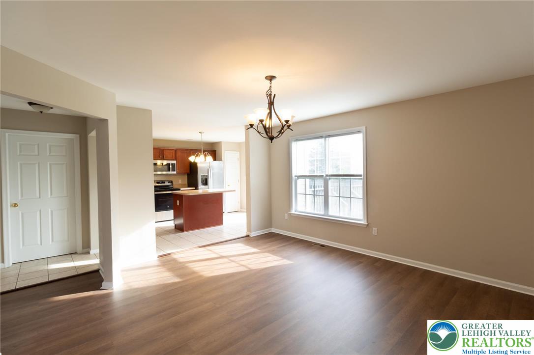 4138 Walter Road Bethlehem, PA 18020 - Photo 16 of 39 an empty room with wooden floor fireplace and windows